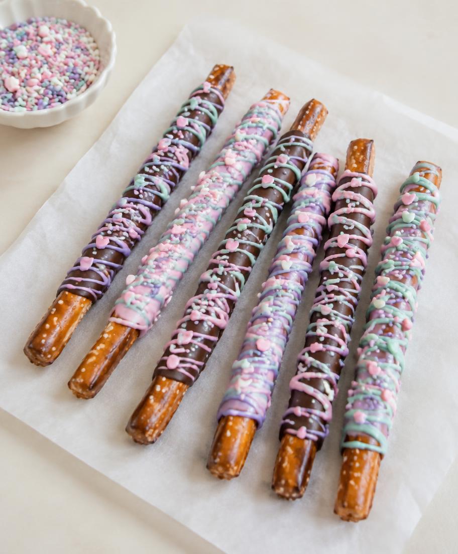 Chocolate-covered pretzel rods with pink, mint and lavender drizzle